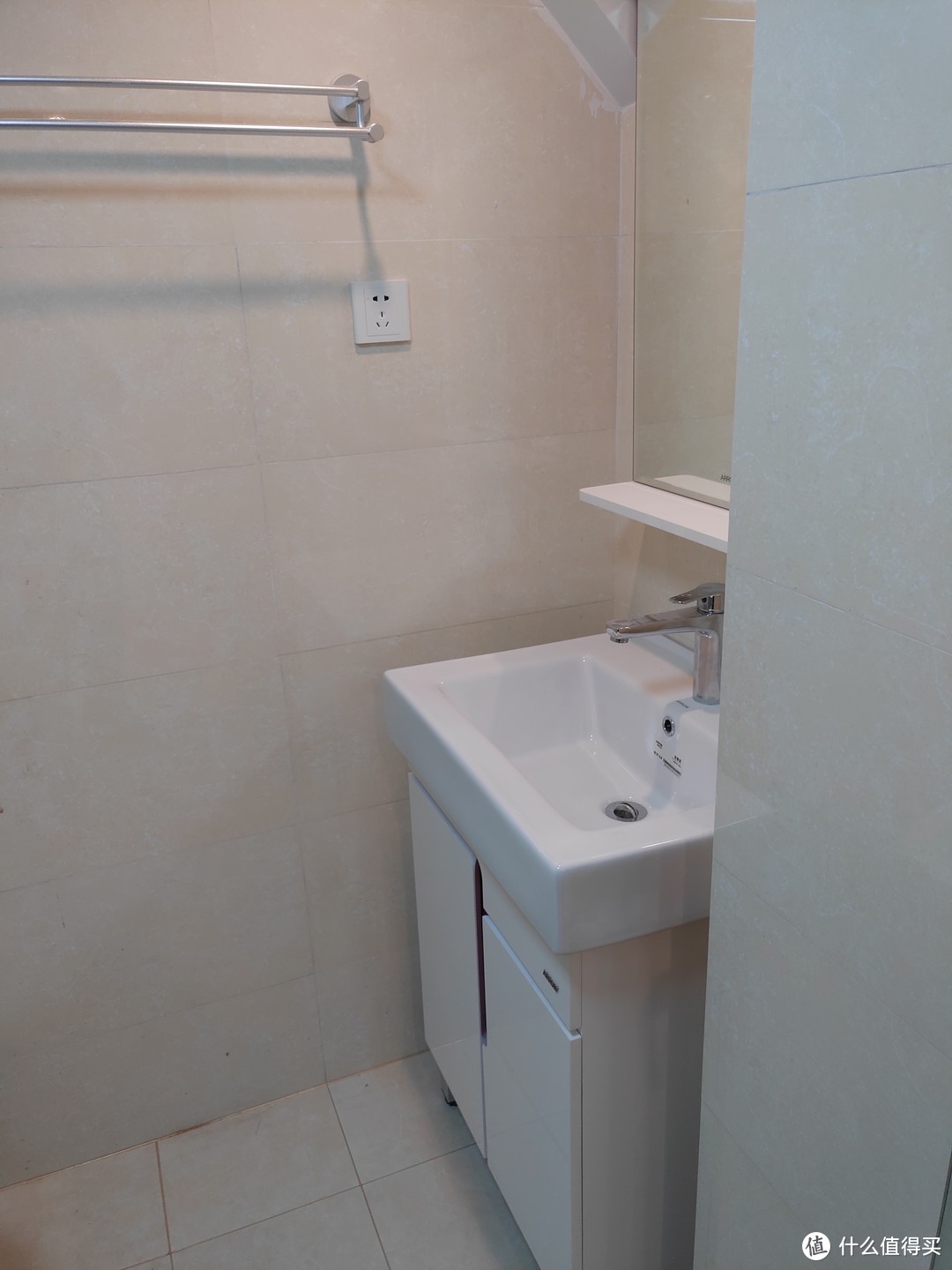 卫生间进门左手是一个洗脸台，同样是小尺寸的独立台盆，两边都没挨到墙。