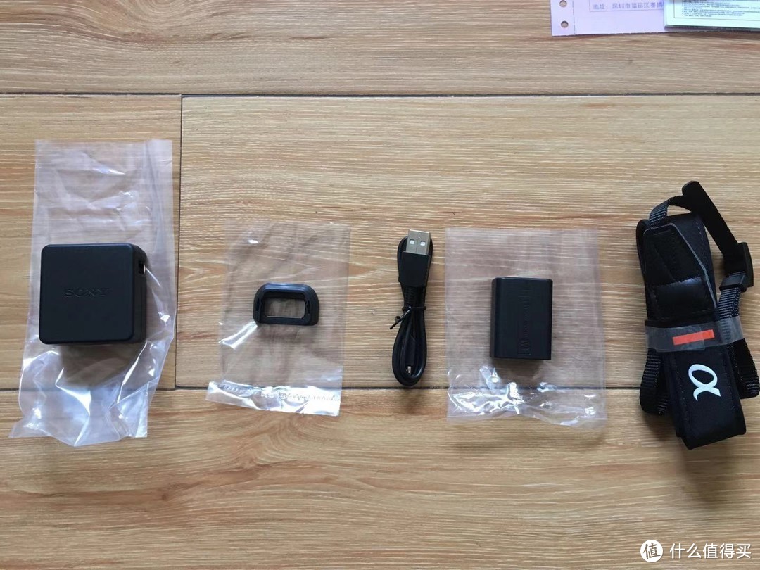全部附件。从左到右分别是：电源适配器，眼罩，Micro USB连接线，原装电池，肩带。